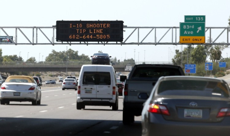 A sign still displays a shooter tip line above Interstate 10 in Phoenix.