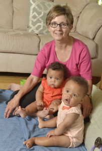 Monica Cote will travel to Philadelphia to see Pope Francis celebrate Mass next Sunday. Cote is a nurse who left her job to care for her twin 8-month-old granddaughters, Eva, left, and Marie.