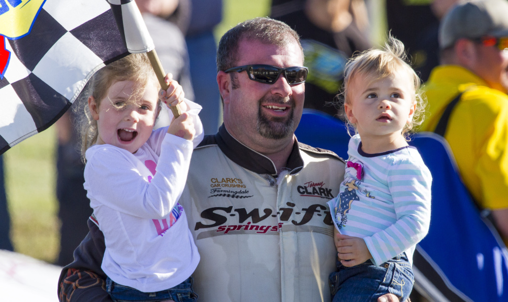 Johnny Clark celebrates with daughters Alivia, left, and Miranda after winning the annual 300-lap Pro All Stars Series on Sunday at Beech Ridge Motor Speedway. Ben McCanna/Staff Photographer