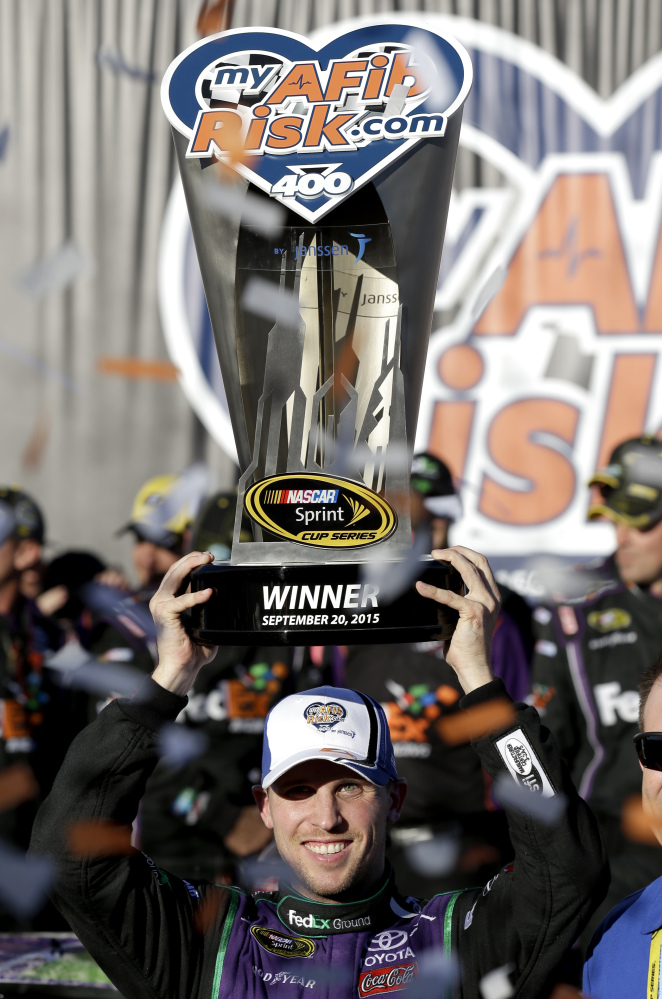 Denny Hamlin celebrates in Victory Lane after winning the NASCAR Sprint Cup race Sunday at Chicagoland Speedway in Joliet, Ill.