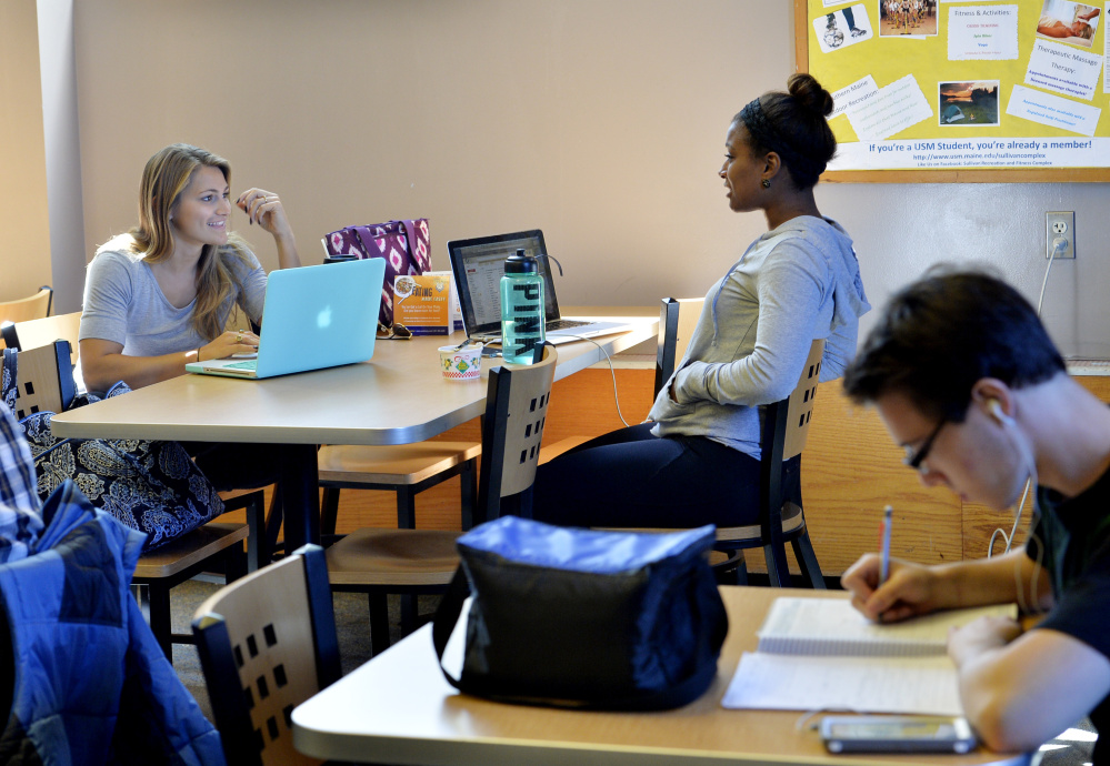 University of Southern Maine students Nicole Kirk, left, and Deonna DaSilva study at the Woodbury Campus Center in Portland on Monday. The university eliminated 51 faculty members last year.