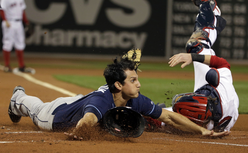 Tampa Bay’s Mikie Mahtook slides safely into home as Red Sox catcher Ryan Hanigan tries to tag him out in the first inning.