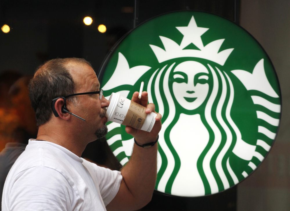 A man drinks a Starbucks beverage in New York.