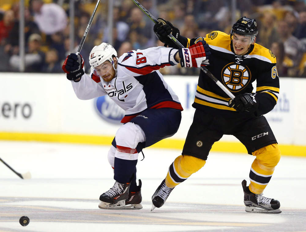 Capitals' Liam O'Brien and Bruins' Justin Hickman battle for the puck during the third period of the Bruins' 2-1 win in a preseason game in Boston on Tuesday.
The Associated Press