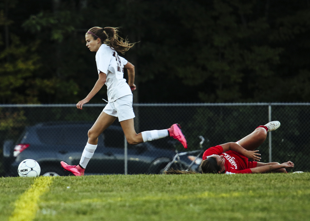 Hallie Shiers of Gorham dribbles past Hannah Miller of Sanford to score Wednesday night during Gorham’s 3-0 victory that sent Sanford to its first setback of the season.