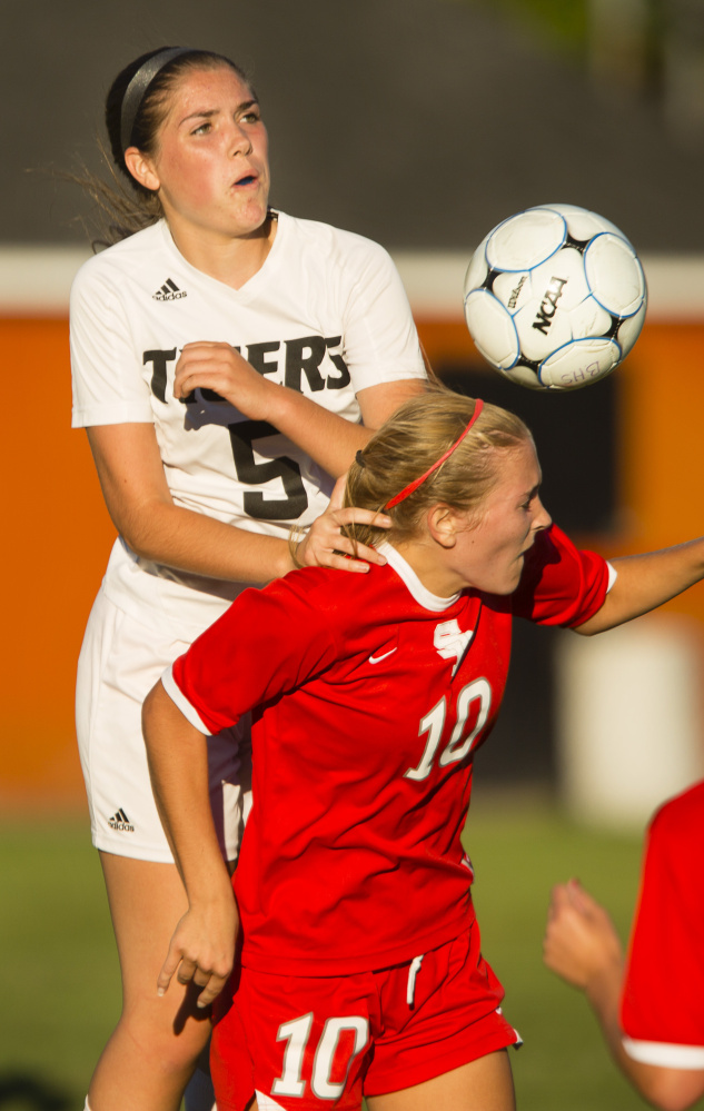 Madison Cantara of Biddeford goes over Callie O’Brien of South Portland to head the ball away Wednesday during South Portland’s 2-1 victory in an SMAA game at Biddeford. O’Brien scored a goal.