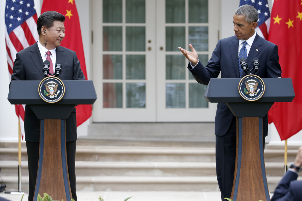 President Barack Obama and Chinese President Xi Jinping hold a joint news conference in the Rose Garden of the White House in Washington on Friday.