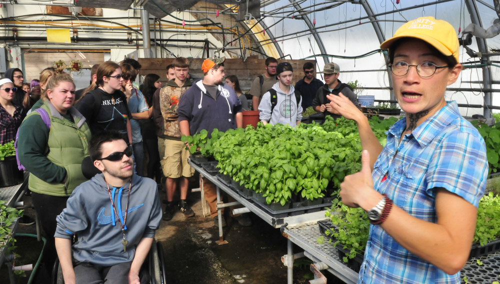 Unity College professor Mary Bulan leads a tour of a greenhouse at the new McKay Farm and Research Station in Thorndike. In the past school year, the center grew 30,000 servings of vegetables for the dining hall.