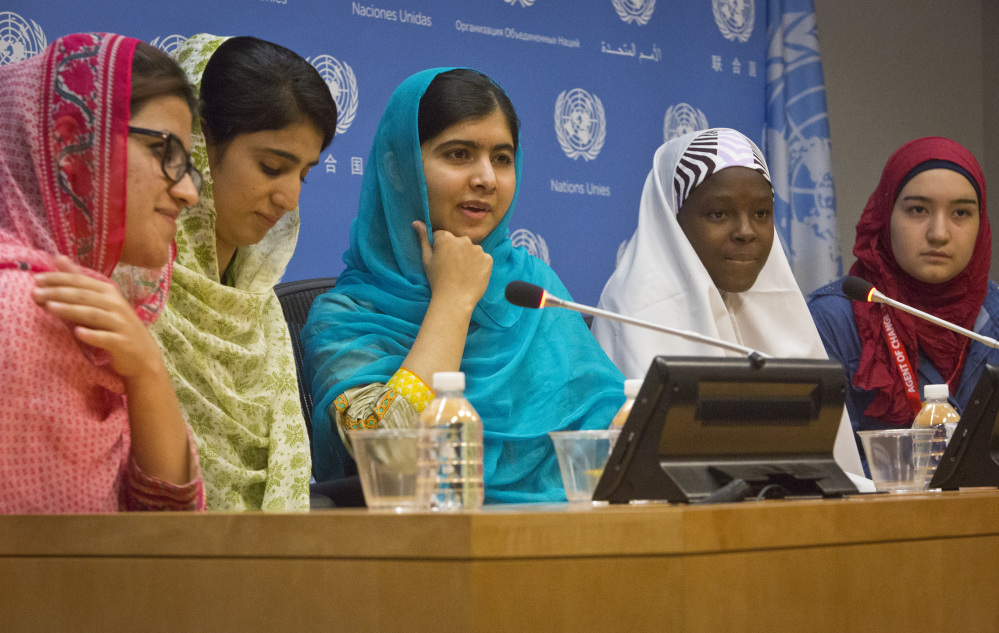 Nobel Peace Prize winner Malala Yousafzai, center, hold a press conference with her friends and youth activists  , Friday Sept. 25, 2015 at United Nations headquarters.  Malala addressed the U.N. General Assembly and urged global leaders to do more to protect and empower young people.  (AP Photo/Bebeto Matthews)