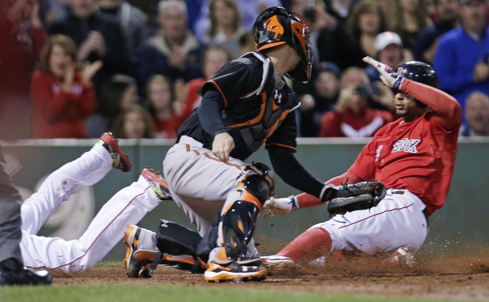 Orioles catcher Caleb Joseph turns as two Red Sox base runners, Dustin Pedroia, left, and Xander Bogaerts, score nearly together on a double by David Ortiz in the sixth inning Friday night.