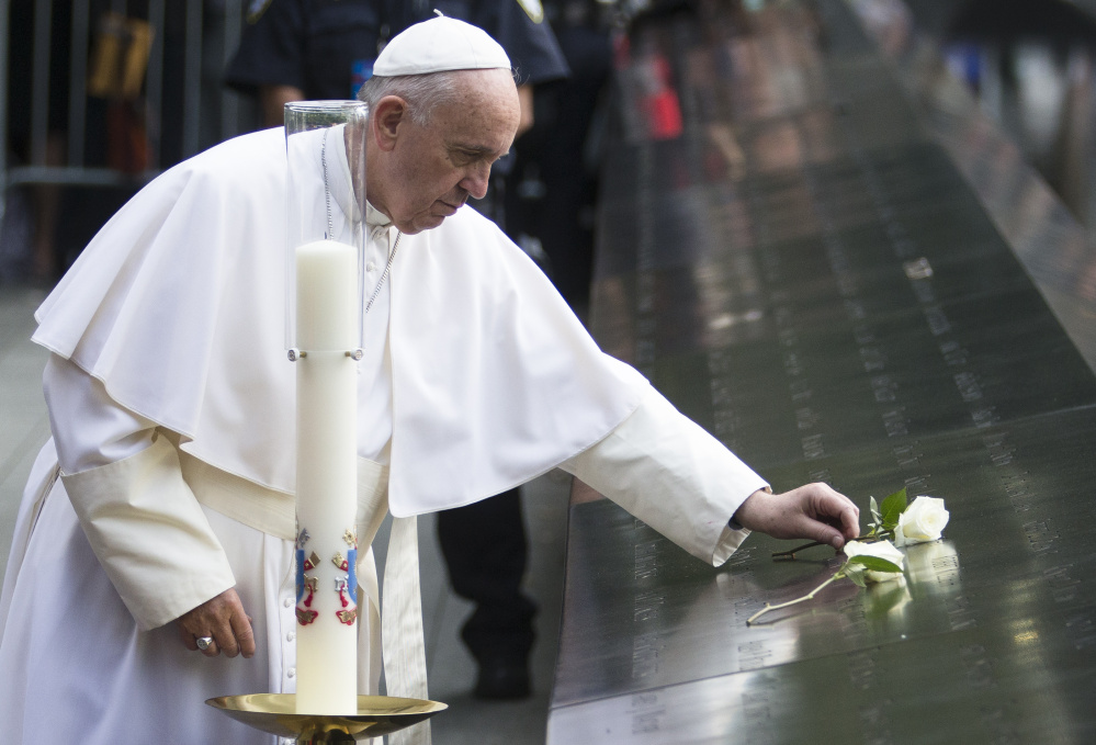 Pope Francis places a white rose at the South Pool of the 9/11 Memorial in downtown Manhattan on Friday. Francis said a prayer of remembrance at an interfaith ceremony at the museum in New York. The pontiff asked God for eternal peace for those killed, as well as healing for the relatives of the nearly 3,000 people killed in the 2001 terror attacks in New York, at the Pentagon and in a field in Pennsylvania.