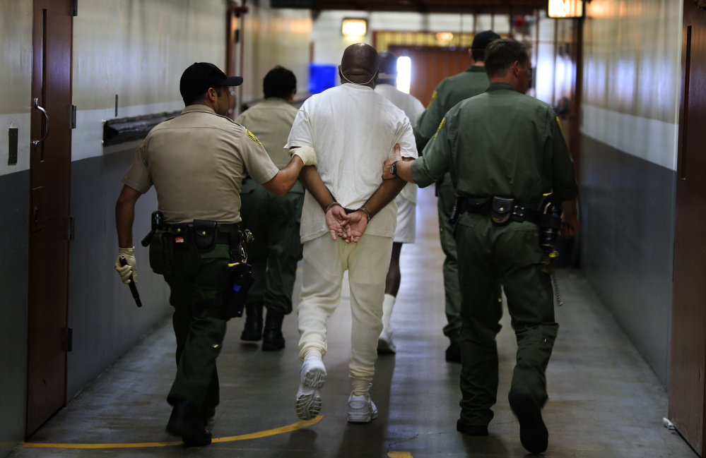 Inmates are walked to a medical unit at Pelican Bay State Prison, Crescent City, Calif. There have been recent efforts to free nonviolent offenders serving disproportionate sentences.