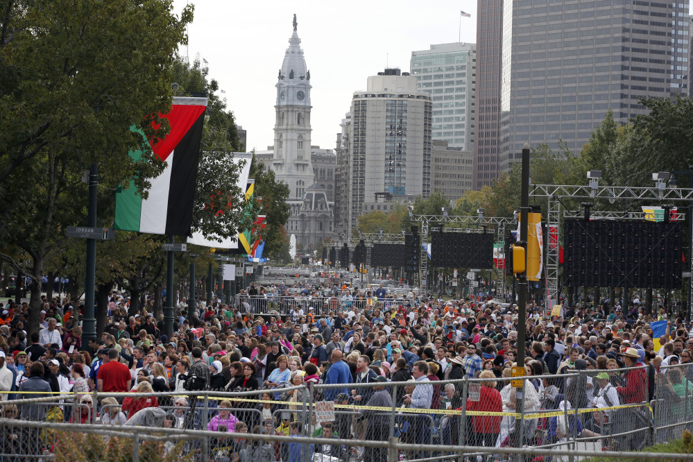 A crowd of people gathers on Benjamin Franklin Parkway before a Mass celebtated by Pope Francis on Sunday in Philadelphia.