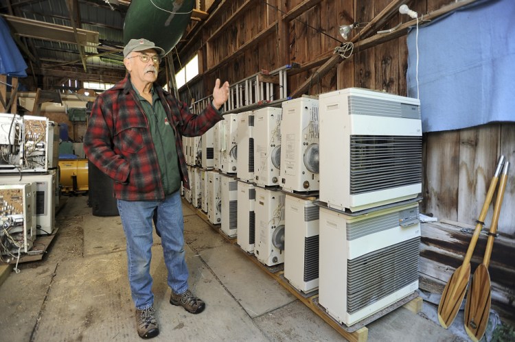 Ken Gaudin, owner of Ken’s Monitor & Toyo Sales, stands beside monitor heaters that he will renovate or cannibalize for parts. The demand for the efficient, kerosene-burning Monitor heaters – and for parts to fix them – is great. 