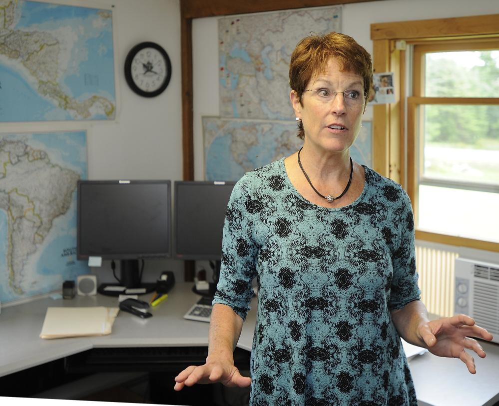 In an office lined with maps, President Connie Justice says Planson International’s job is to come up with the best technology solution at the lowest possible price.