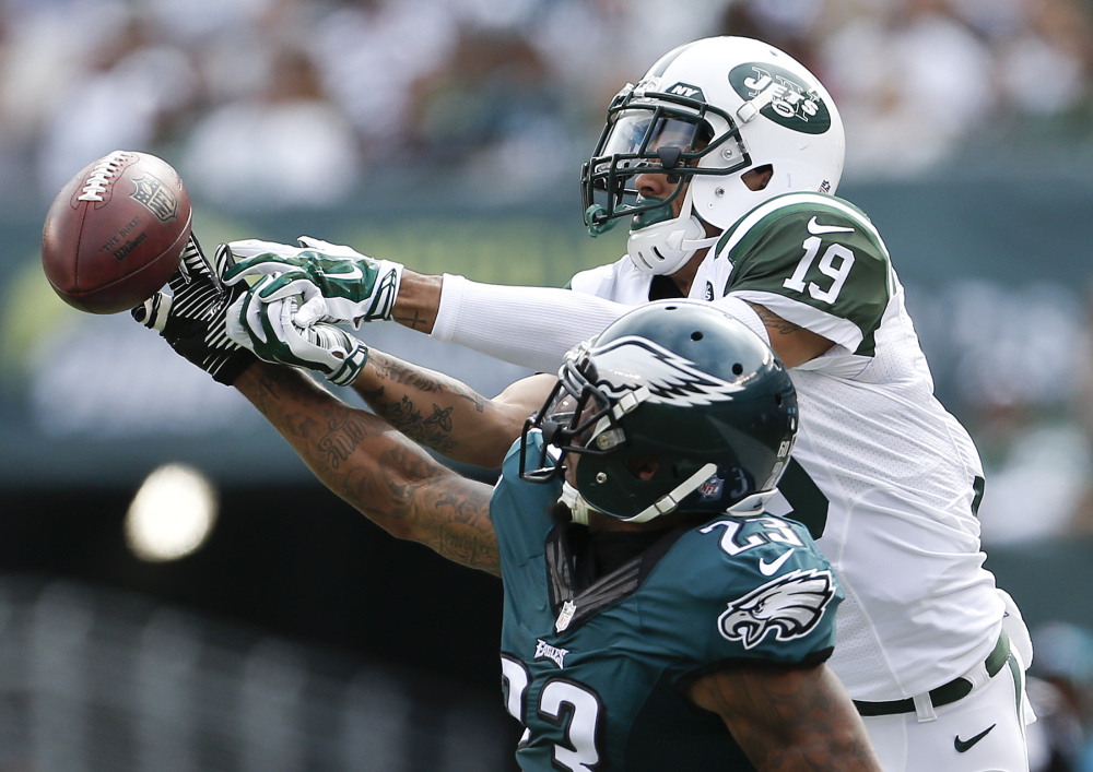 Eagles cornerback Nolan Carroll, front, breaks up a pass intended for Jets wide receiver Devin Smith during Philadelphia’s 24-17 win Sunday in East Rutherford, N.J.
