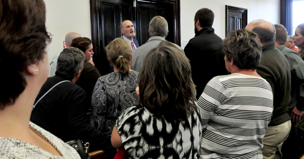 Defense attorney Leonard Sharon speaks with family and friends who filled the Somerset County Superior Court in Skowhegan on Monday, following the sentencing of Andrew Maderios on domestic violence charges.