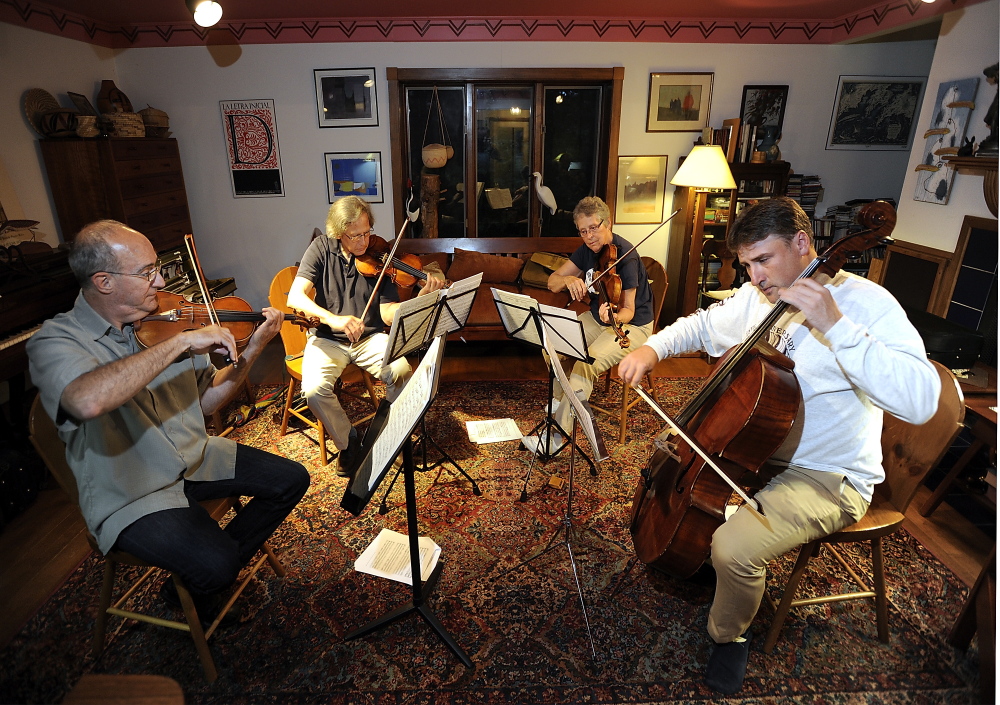 Members of the Portland String Quartet rehearse with new cellist, Patrick Owen. From left are: Dean Stein, first violin; Ronald Lantz, second violin; Julia Adams, viola; and Owen. 
Gordon Chibroski/Staff Photographer