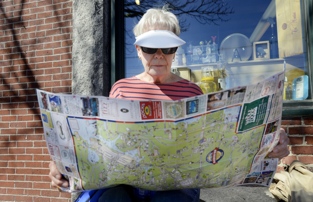 Catherine Guzi, 73, of South Carolina plans her next stop while visiting the Old Port in Portland. The cruise ship Aurora, carrying nearly 2,000 passengers, docked Monday in the harbor. By one estimate, 48 percent of U.S. cruise ship passengers are 50 or older.