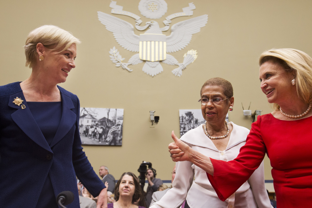 House Oversight and Government Reform Committee member Rep. Carolyn Maloney, D-N.Y., right, accompanied by fellow committee member Del. Eleanor Holmes Norton, D-D.C., center, gives a thumbs-up to Planned Parenthood Federation of America President Cecile Richards, prior to Richards testifying before the committee Tuesday on Capitol Hill in Washington.
