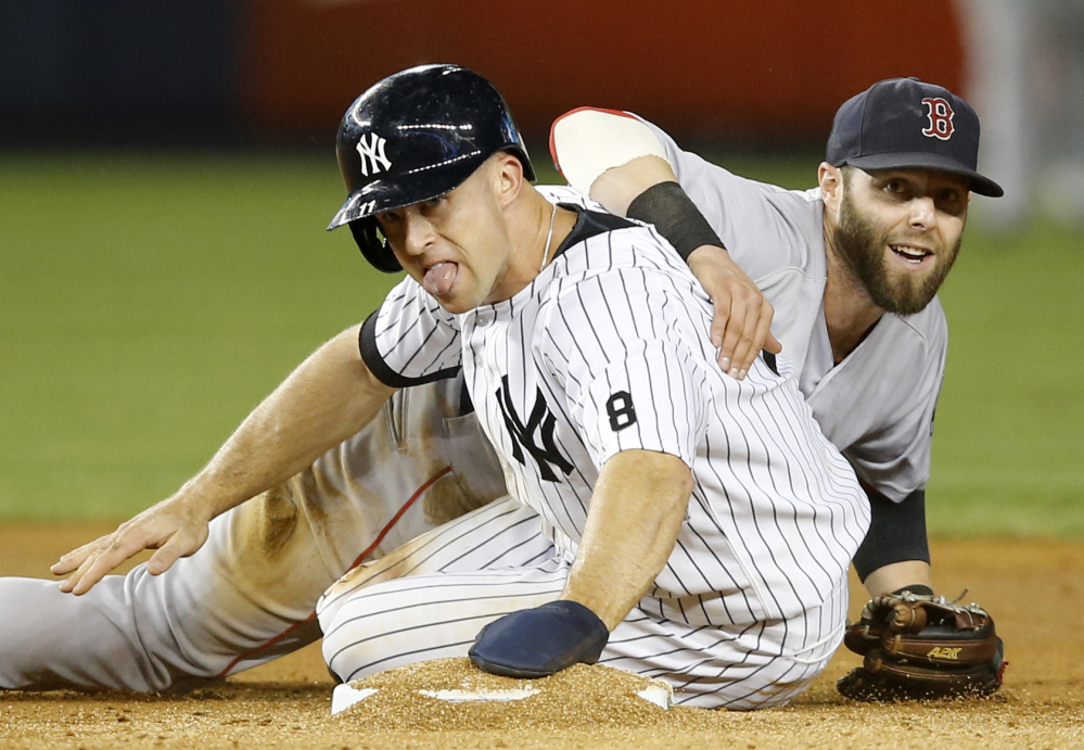 Dustin Pedroia looks from behind the Yankees’ Brett Gardner after forcing Gardner out in the fifth inning when Alex Rodriguez hit into double play.