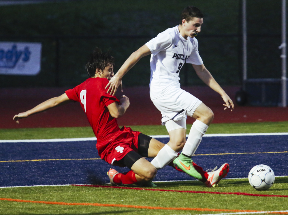South Portland defender Patrick Graff attempts to gain possession of the ball while Portland player Alex Frank moves toward South Portland's goal at Fitzpatrick Stadium in Portland on Tuesday. Whitney Hayward/Staff Photographer