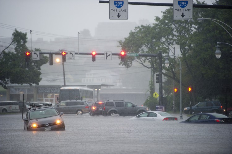 Disabled cars sit in water at the corner of Franklin and Somerset streets in Portland during Wednesday's deluge. Flooding has been a problem in the area for decades, but the city has yet to take aggressive steps to address it.
Gabe Souza/Staff Photographer