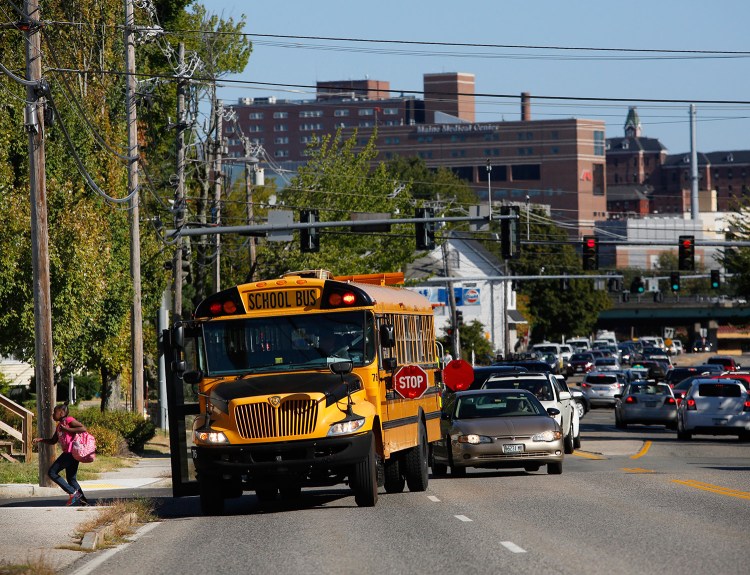 A school bus lets off a student at the corner of Congress and Frances streets on Thursday.
Derek Davis/Staff Photographer