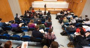 Orono, Maine--02-26-2015--Dr. James Breece teaches macroeconomics to a nearly full lecture hall on Thursday at the Orono campus. University of Maine freshman Josh Salkind graduated last year from a very small high school in Aroostook County and chose U Maine because he wanted to experience a large university. U Maine showed post-graduate earnings of $38,700, with an average annual cost of $16,831 and student debt of $27,000. Kevin Bennett Photo