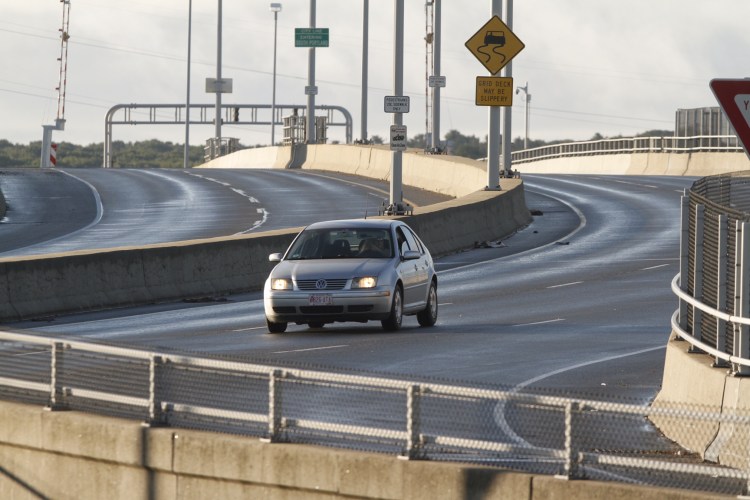A car drives the wrong way back off the Casco Bay Bridge after being turned back by police early on Monday morning. Officers had closed the bridge to traffic after a man on the bridge had threatened suicide.