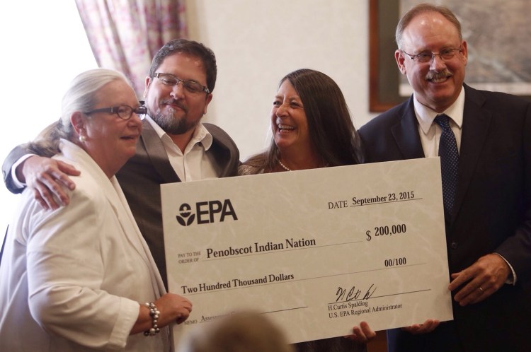 Left to right, Cathy Goodwin of the office of U.S. Sen. Susan Collins, Bill Thompson, Penobscot Nation vice chief, Bonita Pothier of the office of U.S. Sen. Angus King and Curt Spalding, EPA's New England Region administrator, hold a replica of a check that was presented to the Penobscot Nation representing a $200,000 assessment grant. The EPA announced the funds were being awarded to address contaminated sites in Maine, during a news conference at Biddeford City Hall on Wednesday.