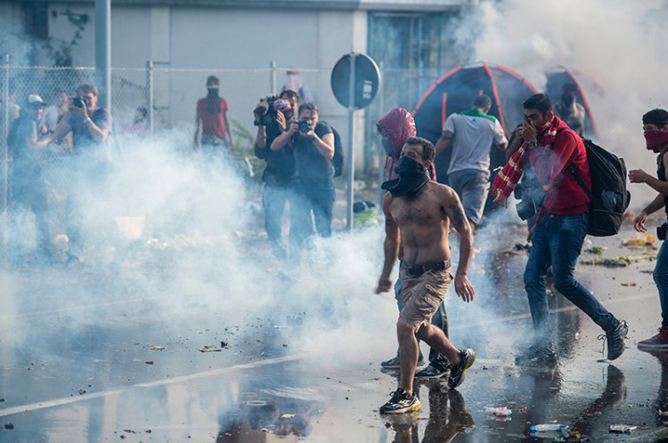 Hungarian police use tear gas at a border crossing into Hungary, near Horgos, Serbia.