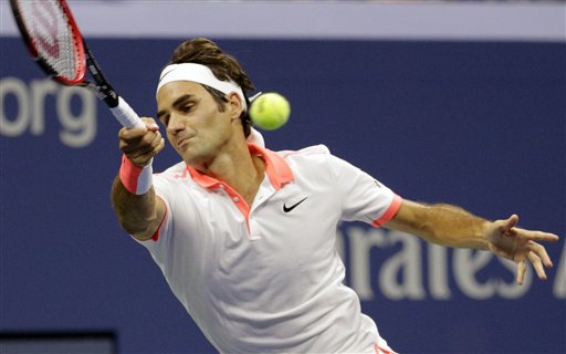 Roger Federer returns a shot to Stan Wawrinka, during their semifinal match at the U.S. Open on Friday. The Associated Press