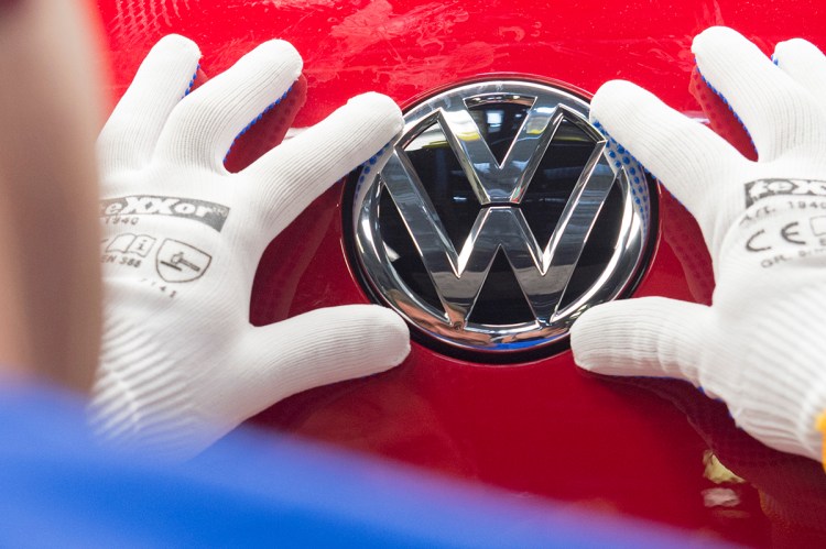 A worker checks the Volkswagen badge on a Golf car in this In this Sept. 6, 2015, photo. . Above and beyond legal problems, the  company's growing emissions scandal is a huge problem for a brand long identified with trustworthiness and reliability. And there are concerns that could spill over into a wider image problem for goods "made in Germany." The Associated Press