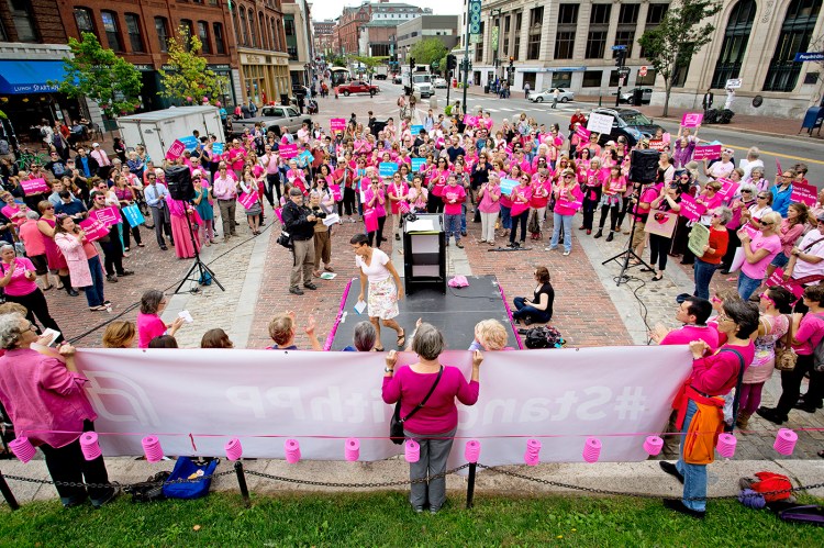 Eliza Townsend of the Maine Woman's Lobby exits the stage after speaking at a rally for Planned Parenthood in Monument Square in September.