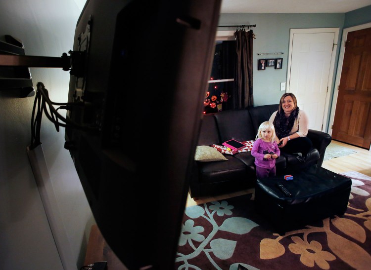 Lyndsey Patton, a Comcast customer in Topsham who takes online courses and streams movies, has discovered that Comcast has implemented a data allowance on her account. Patton watches a show with her 3-year-old daughter Zoey in their living room. 