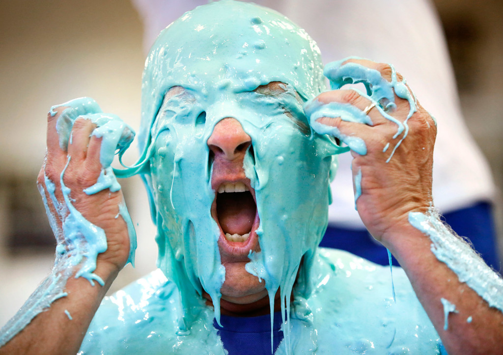 Westbrook High School Principal Jon Ross reacts after being slimed as part of a fundraiser for the Latin Club during an annual pep rally at the school Wednesday. (Derek Davis/Staff Photographer)