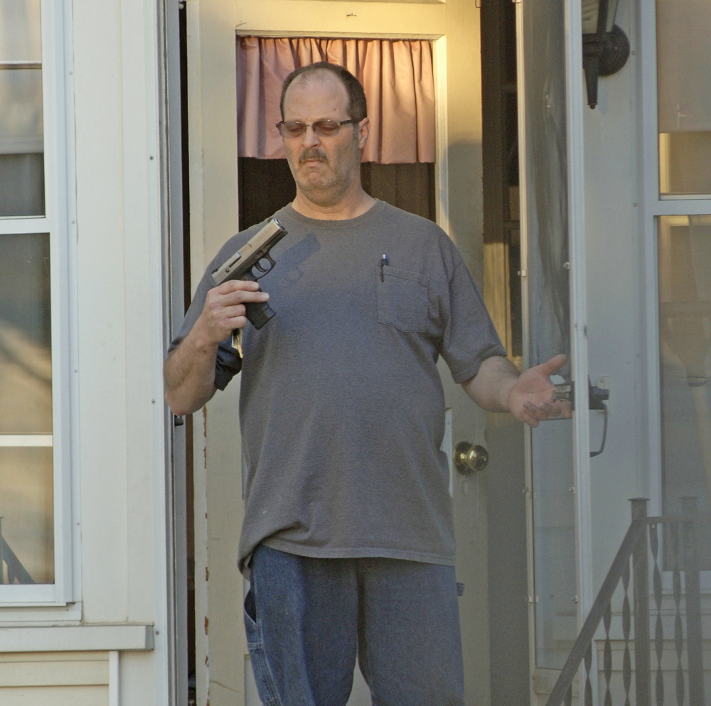 A photo taken in May 2014 by Barry Sturk shows Wilfred Morissette holding a handgun on First Street in Winslow. Wilfred Morissette pleaded guilty Thursday to pointing a loaded gun at two of his sons and Sturk, the boyfriend of his ex-wife.