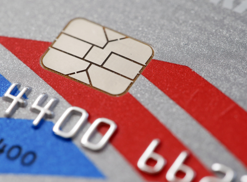 The new credit cards with embedded microchips are “dipped” into a slot for five or 10 seconds, rather than quickly swiped like magnetic-strip cards.