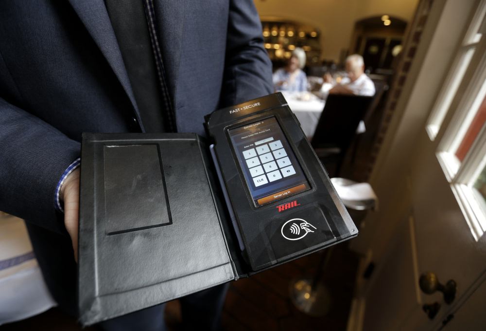 This tableside credit card processing device will be used at a New Orleans restaurant once microchip cards are phased in and magnetic-strip cards, which are easier for thieves to copy using stolen numbers, are phased out.