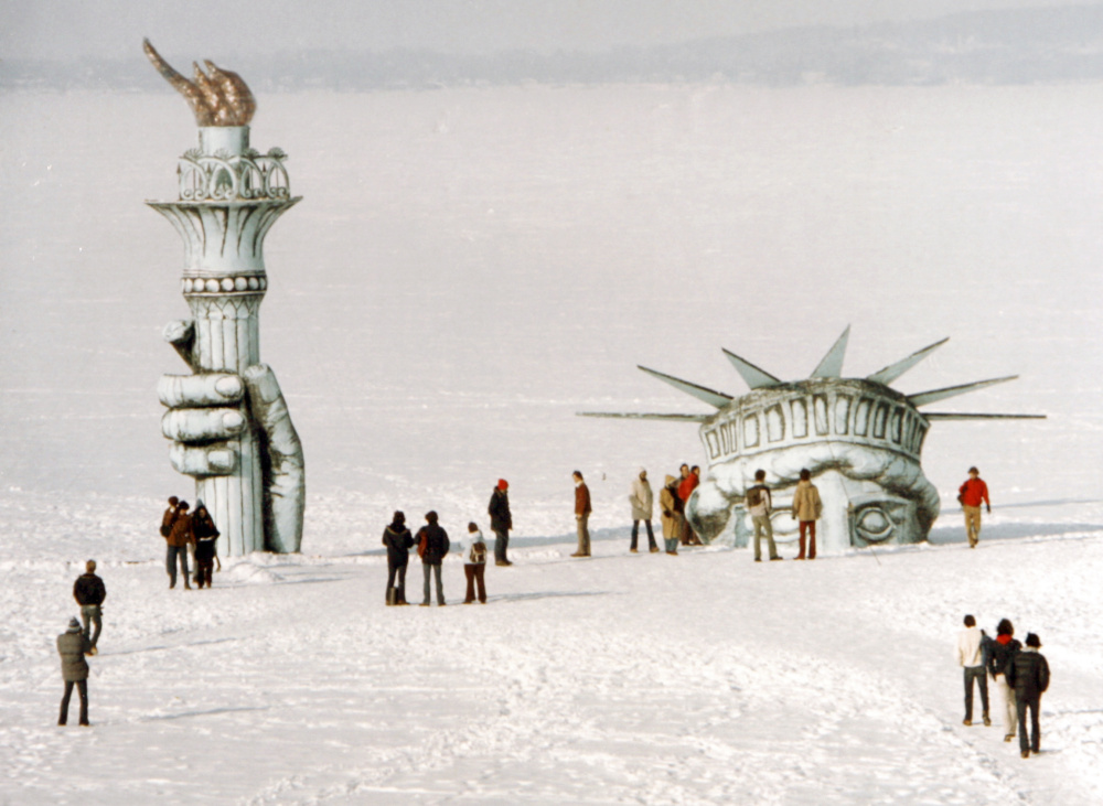 Madison, Wis., residents surround “Miss Liberty” that appears to be poking through the ice of Lake Mendota in 1979. The stunt was the handiwork of the whimsical Pail & Shovel Party, headed by Leon Varjian and Jim Mallon.