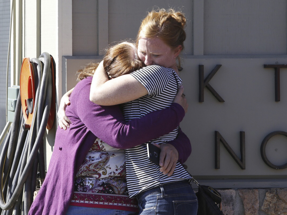 Umpqua Community College alumnus Donice Smith, left, is embraced after she said one of her former teachers was shot dead, near the site of a mass shooting at the college in Roseburg, Oregon, on Thursday.
