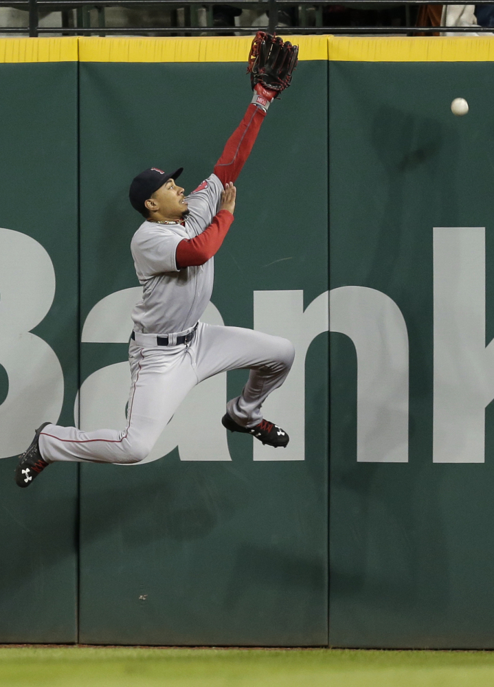 Mookie Betts jumps at the wall but can’t reach a ball hit for an RBI double by the Indians’ Yan Gomes in the fifth inning of Cleveland’s win. Carlos Santana scored on the play.