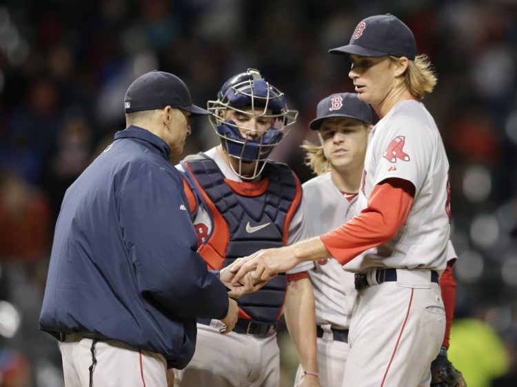 Red Sox starter Henry Owens hands off the ball as he’s relieved in the fifth inning of a rough outing Friday night in Cleveland.