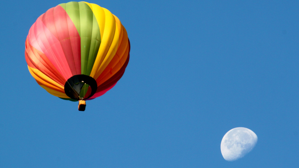 A hot air balloon passes in front of the moon as dozens
wax poetic, pls. dgsl;fjk dfsklj dfklj dfjkl fdjklkjfglslk;jsajdl;fkjklkfsadjl s;laksdjflskj