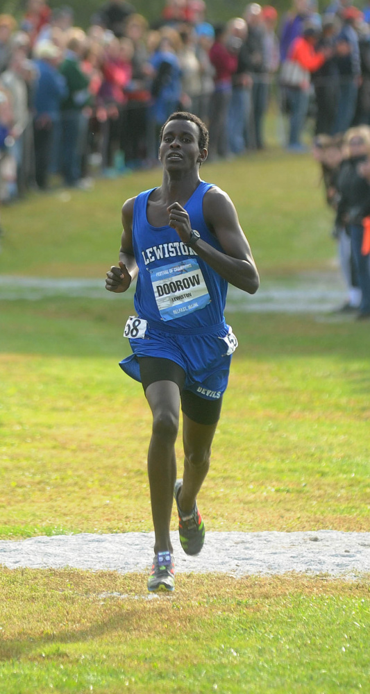 Osman Doorow of Lewiston approaches the finish line to win the boys’ race on Saturday.