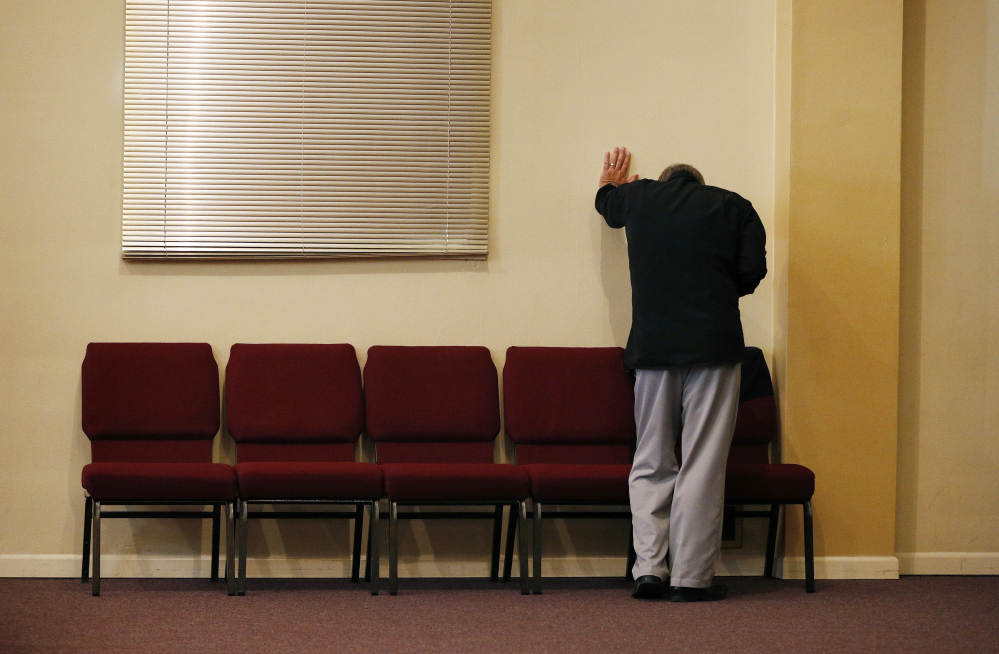 Pastor Randy Scroggins, of the New Beginnings Church of God, cries in his Roseburg, Ore., church Saturday after speaking with the mother of one of the nine people shot and killed by Christoper Sean Harper-Mercer this past Thursday. 