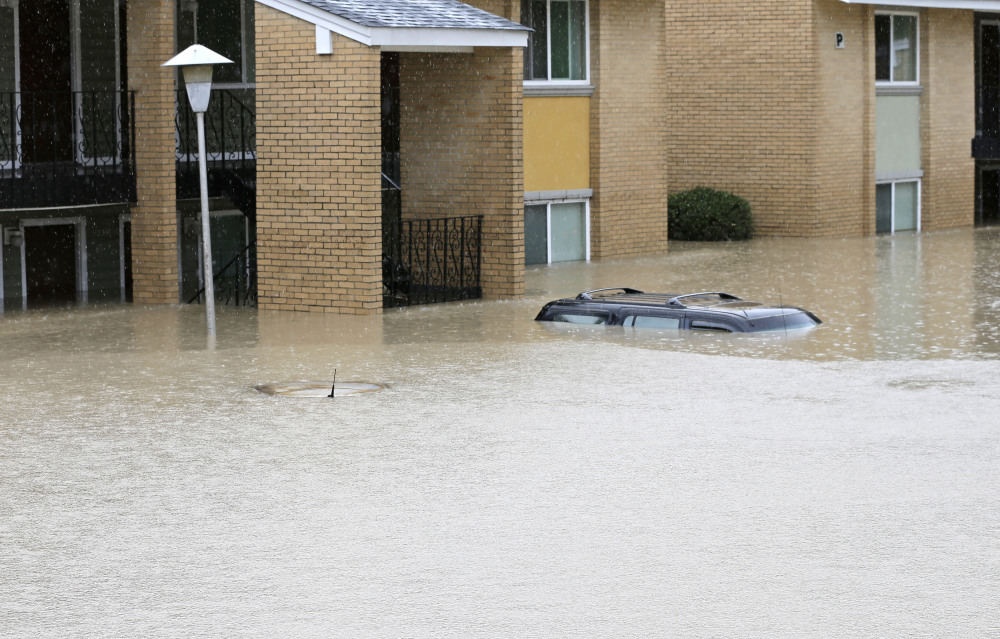 Floodwaters engulf cars at an apartment complex in Columbia, S.C., on Sunday. 