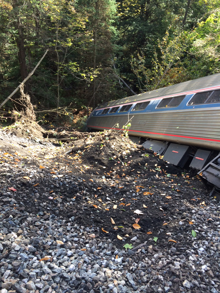 One of the cars of an Amtrak train is seen down an embankment after the train derailed Monday near Roxbury, Vt. The Associated Press