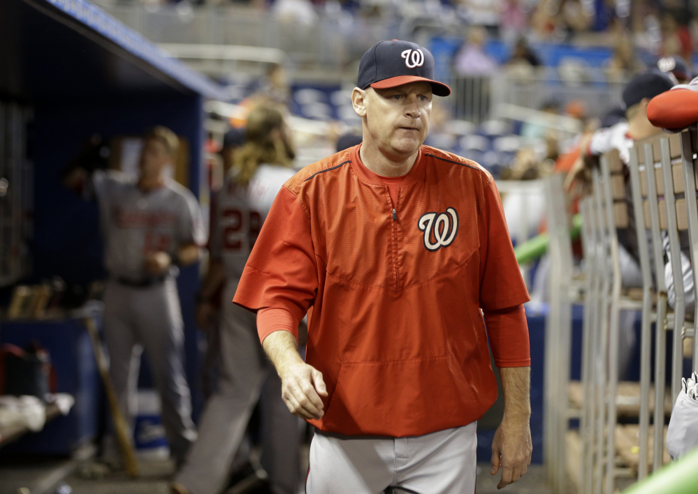 In this photo taken Sept. 13, 2015, Washington Nationals manager Matt Williams walks in the dugout during a baseball game against the Miami Marlins in Miami.